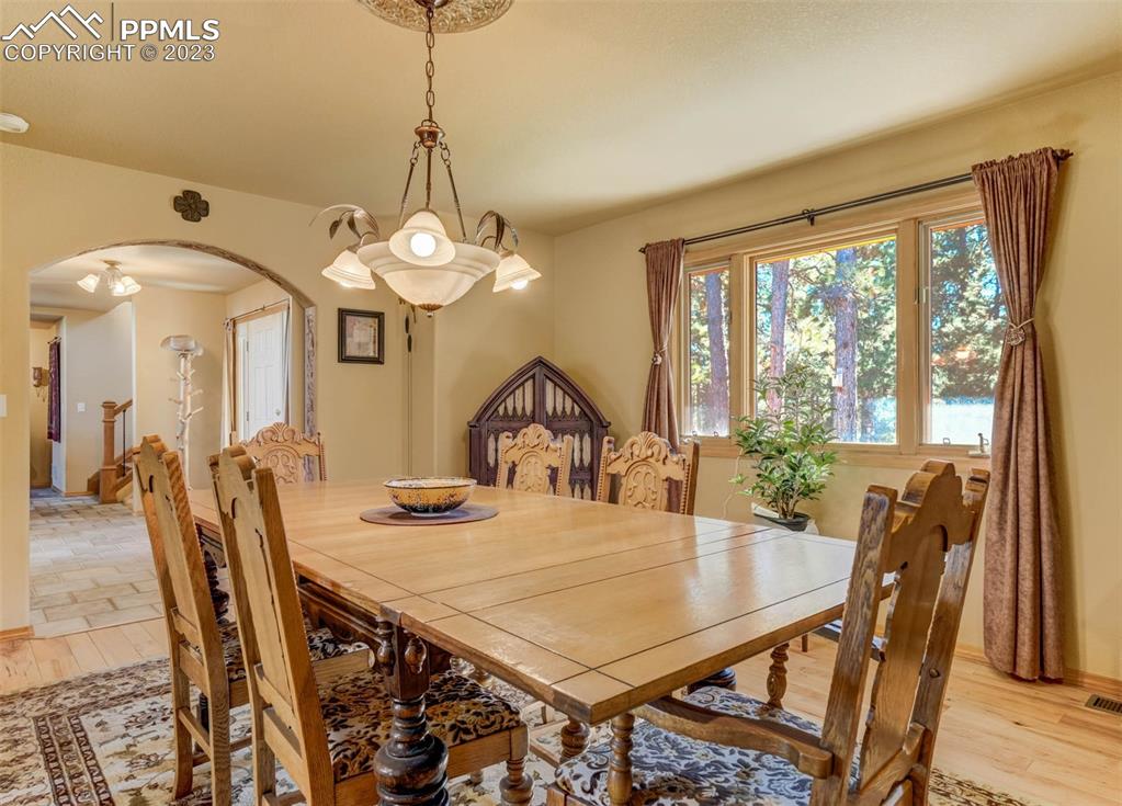 17305 Goshawk Road Colorado Springs, CO 80908 - Photo 24 of 50 a view of a dining room with furniture window and wooden floor