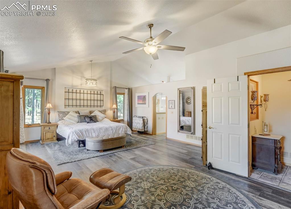 17305 Goshawk Road Colorado Springs, CO 80908 - Photo 28 of 50 a bedroom with a bed and glass walk in closet