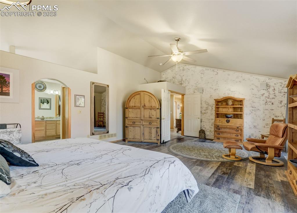 17305 Goshawk Road Colorado Springs, CO 80908 - Photo 29 of 50 a bedroom with a bed and a chandelier
