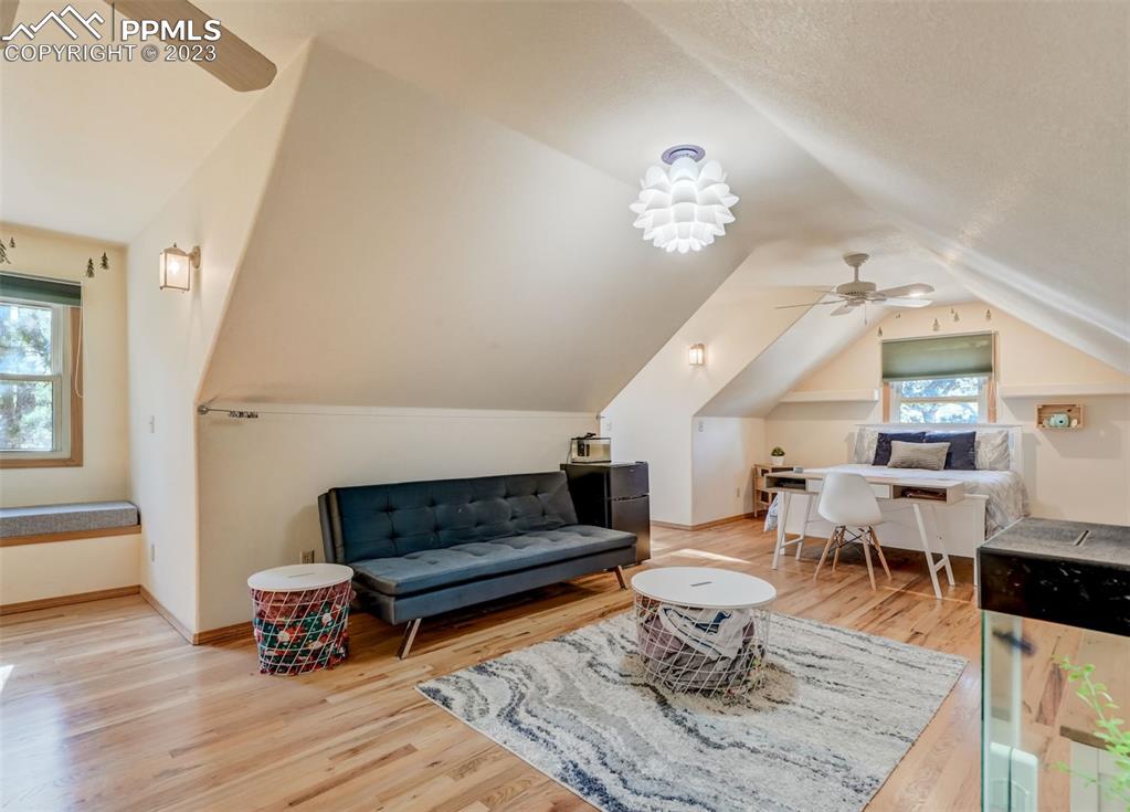 17305 Goshawk Road Colorado Springs, CO 80908 - Photo 38 of 50 a living room with furniture a rug and a window