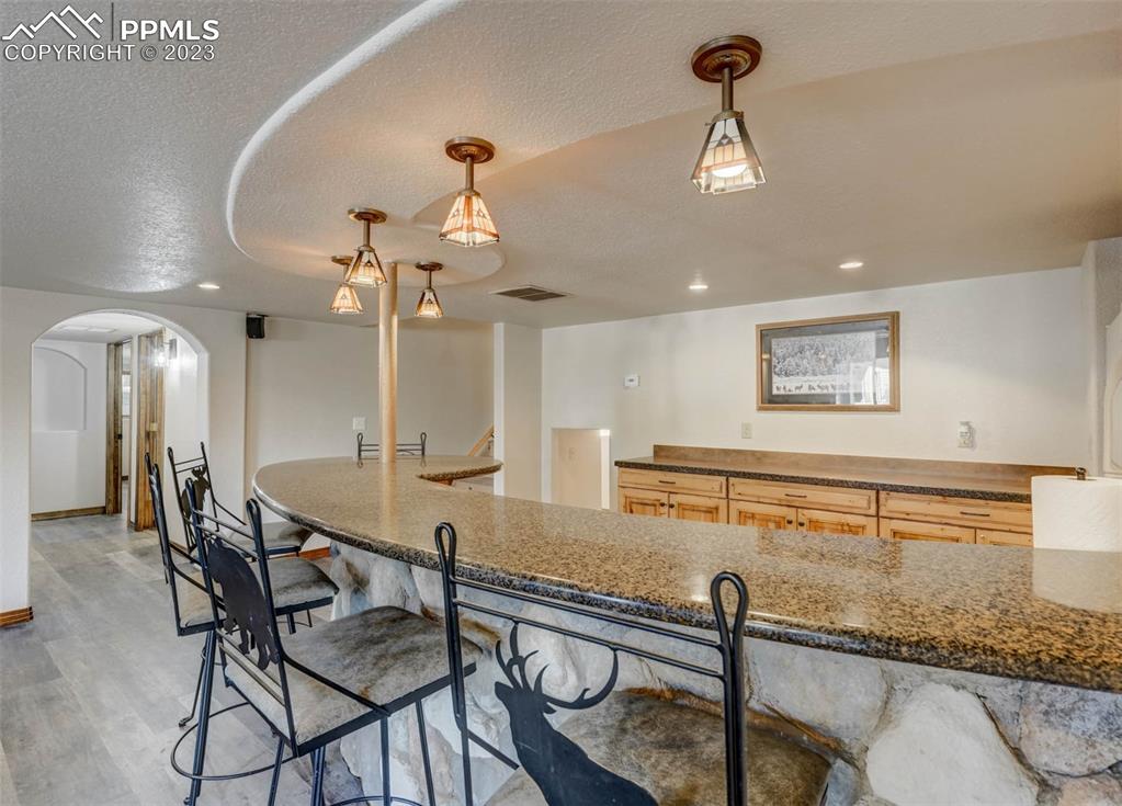 17305 Goshawk Road Colorado Springs, CO 80908 - Photo 41 of 50 a view of a dining room with furniture and a chandelier
