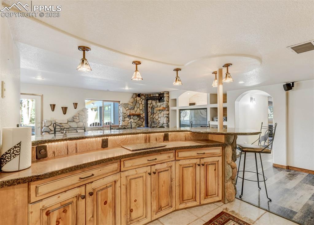 17305 Goshawk Road Colorado Springs, CO 80908 - Photo 42 of 50 a kitchen with granite countertop a sink and cabinets