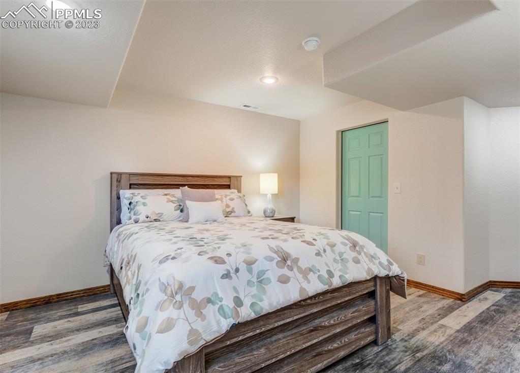 17305 Goshawk Road Colorado Springs, CO 80908 - Photo 44 of 50 a bedroom with a bed and a mirror