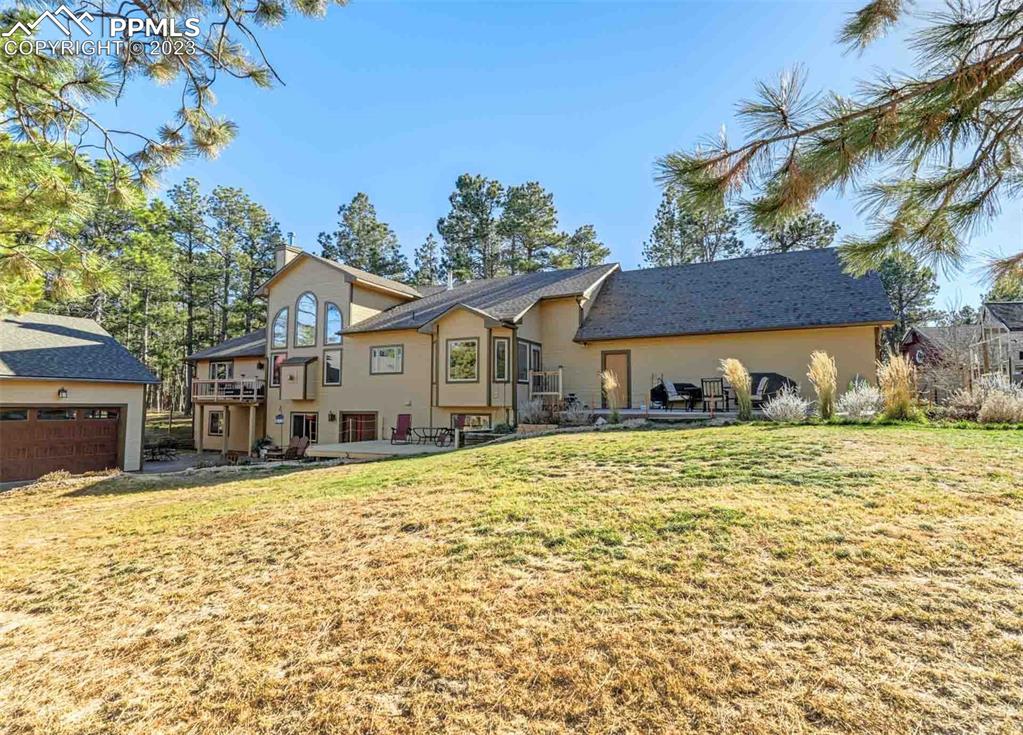 17305 Goshawk Road Colorado Springs, CO 80908 - Photo 7 of 50 a front view of a house with a yard
