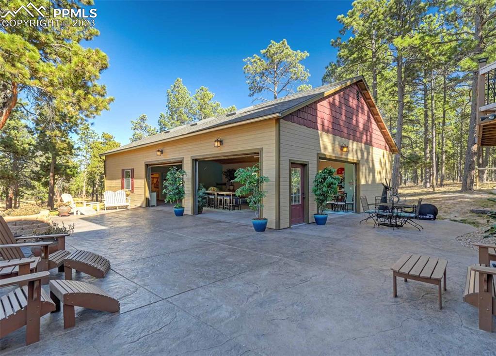 17305 Goshawk Road Colorado Springs, CO 80908 - Photo 8 of 50 a view of a house with backyard sitting area and garden