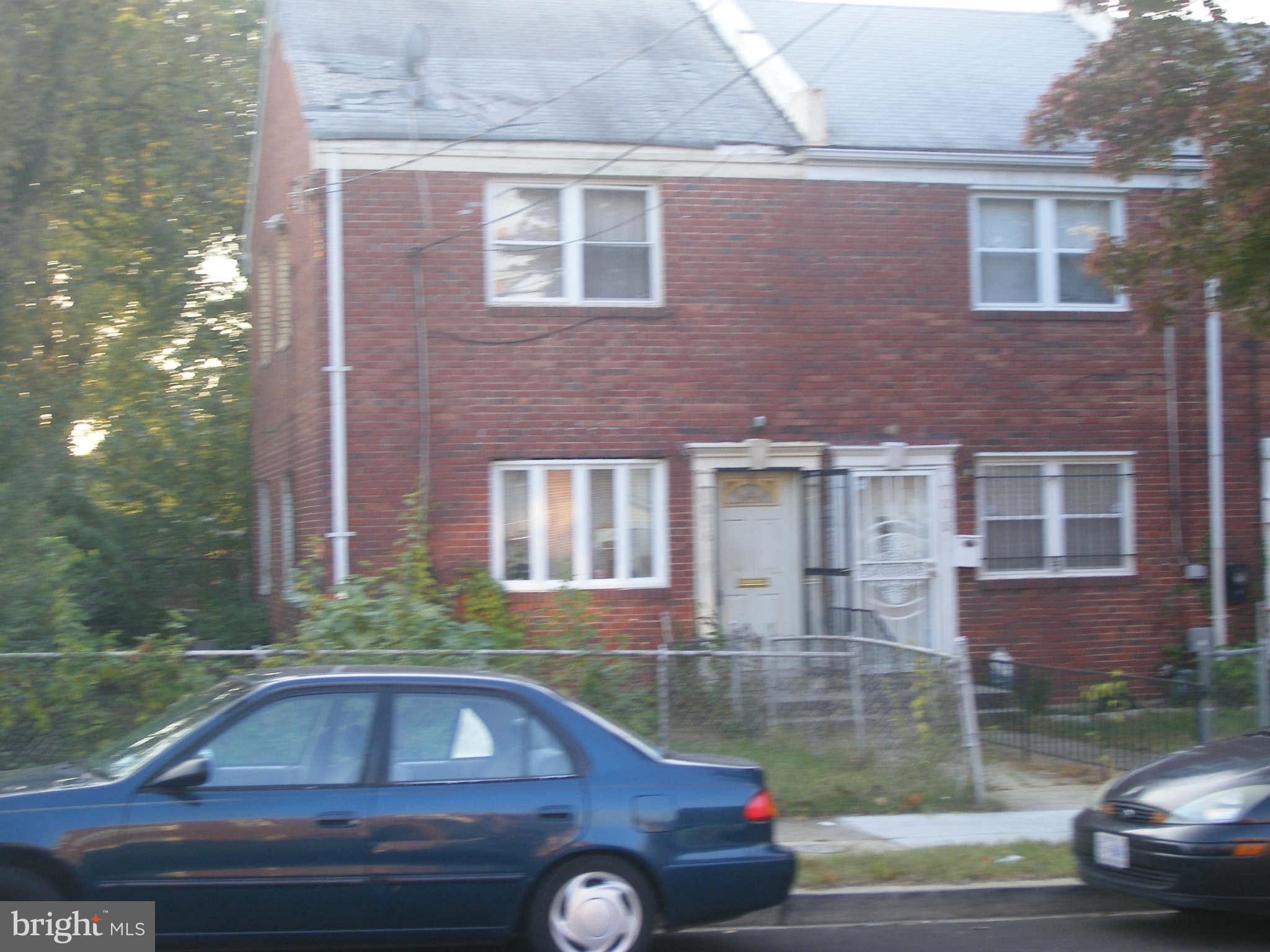 a front view of a house with car parked