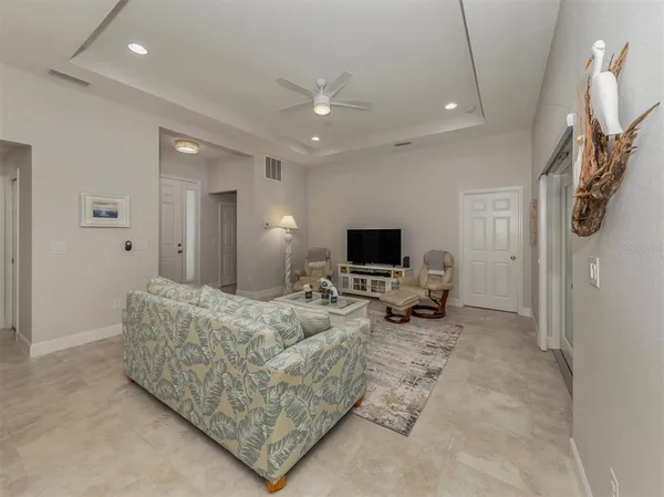 a kitchen with refrigerator and chairs