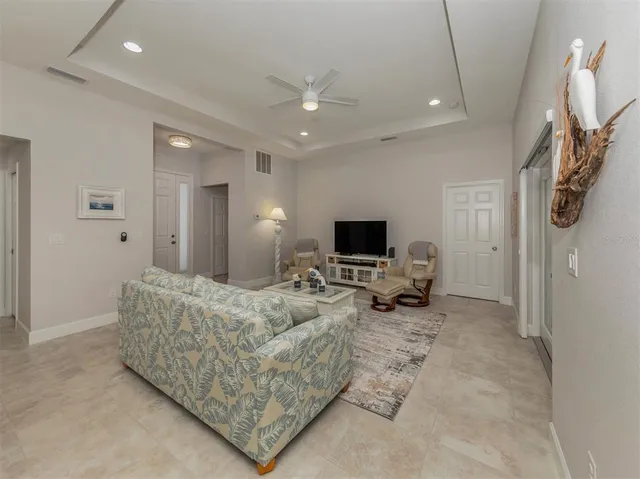 a kitchen with refrigerator and chairs