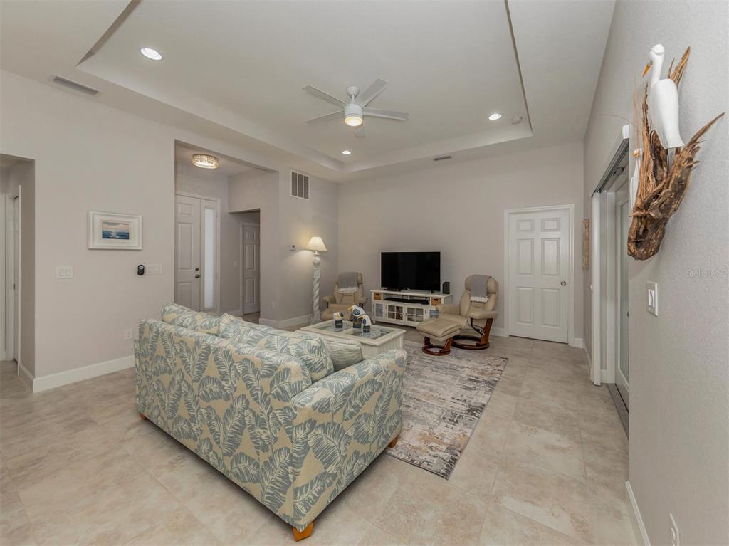 236 Holly Road Venice, FL 34293 - Photo 11 of 88 a living room with furniture and a flat screen tv