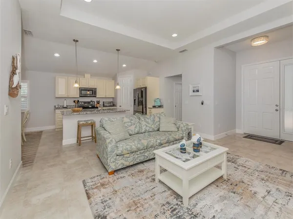 a large kitchen with stainless steel appliances granite countertop a sink stove and refrigerator