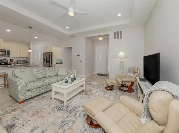 a dining room with furniture a chandelier and wooden floor