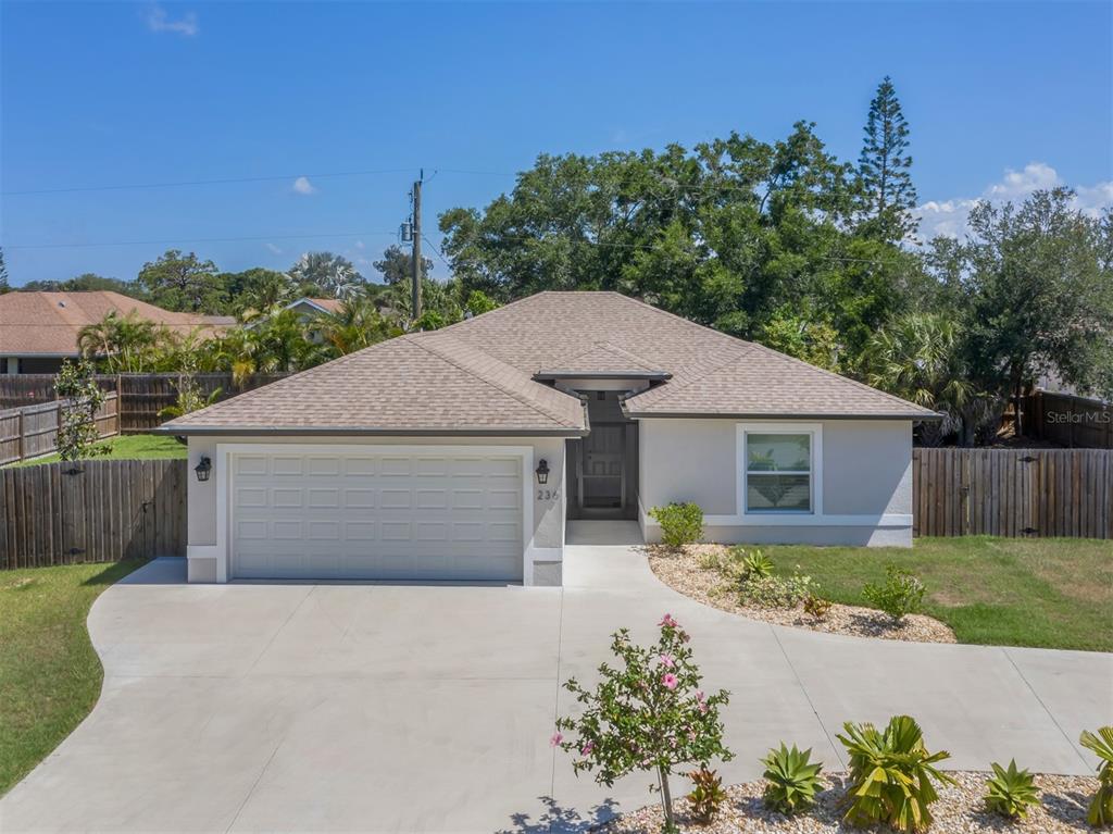 236 Holly Road Venice, FL 34293 - Photo 2 of 88 a front view of house with yard and trees in the background
