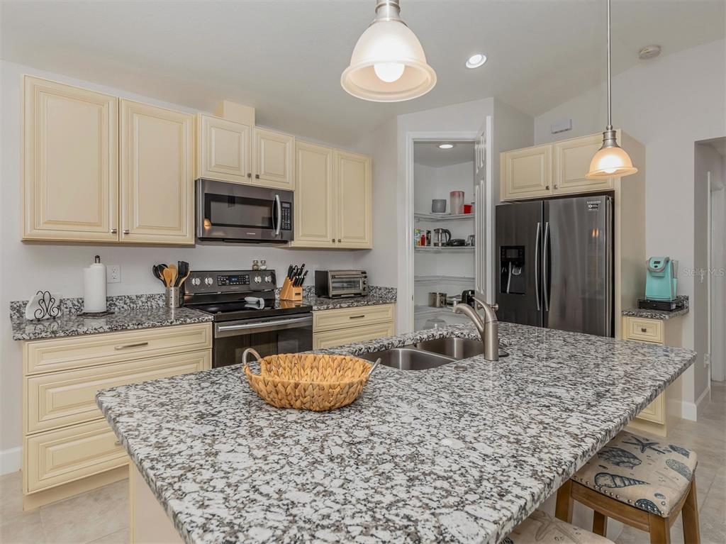 236 Holly Road Venice, FL 34293 - Photo 22 of 88 a kitchen with a stove a microwave and refrigerator