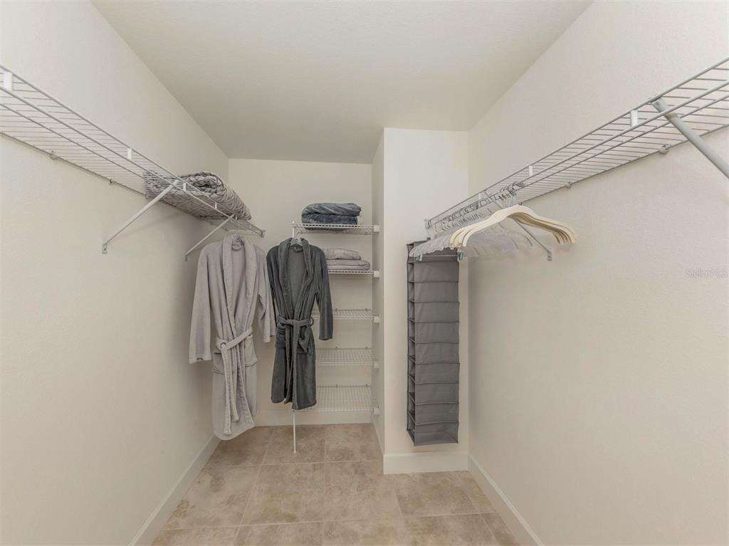 236 Holly Road Venice, FL 34293 - Photo 25 of 88 a view of walk in closet with clothes