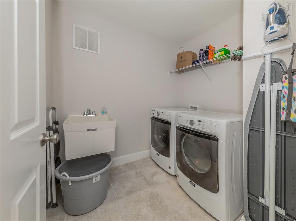 236 Holly Road Venice, FL 34293 - Photo 29 of 88 a utility room with dryer and washer
