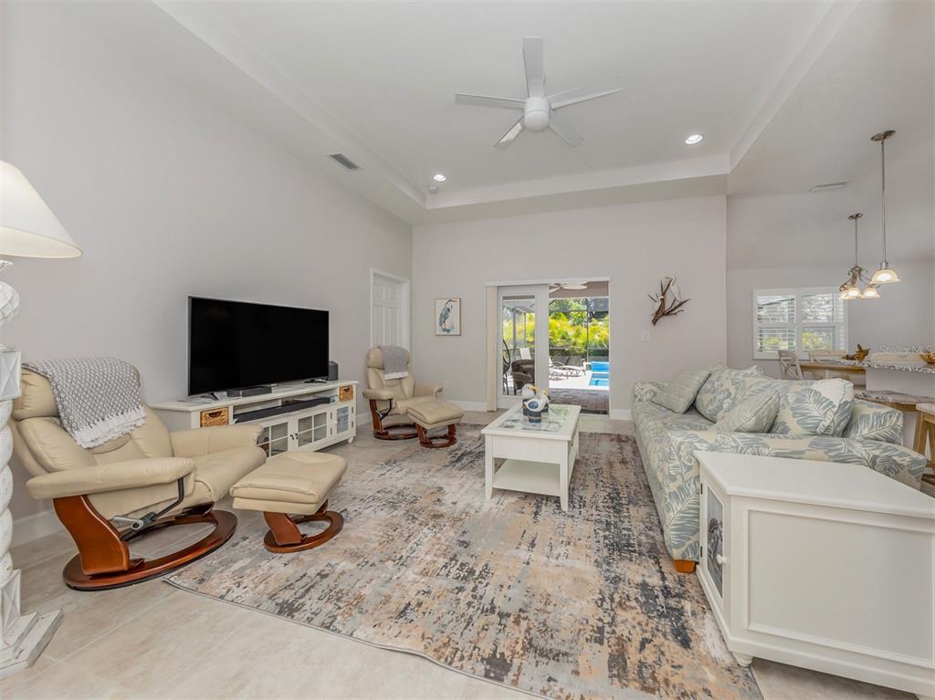 236 Holly Road Venice, FL 34293 - Photo 8 of 88 a living room with furniture and a flat screen tv