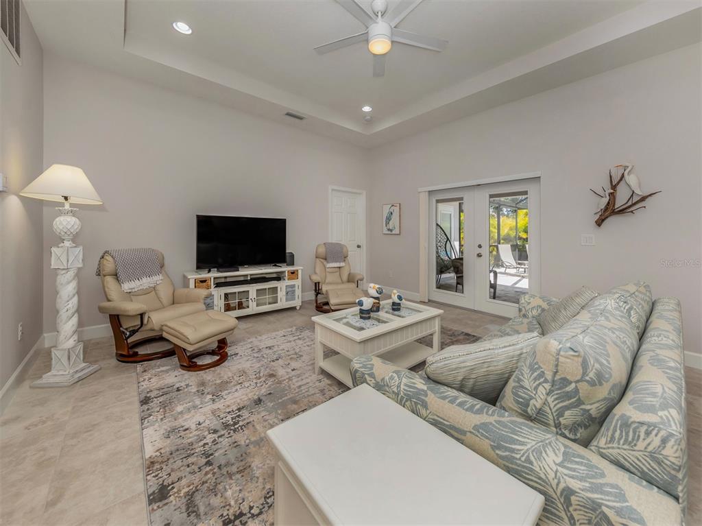 236 Holly Road Venice, FL 34293 - Photo 10 of 88 a living room with furniture and a flat screen tv
