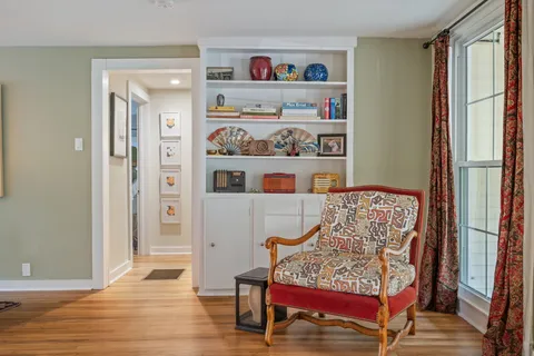 a dining room filled with furniture and a potted plant