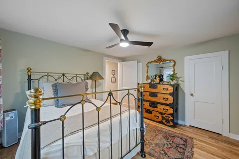 a view of a house with a large tree and a yard