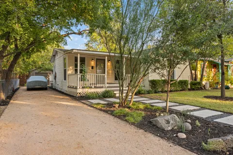 a front view of a house with a garden