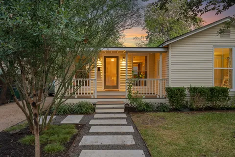a front view of a house with a bench