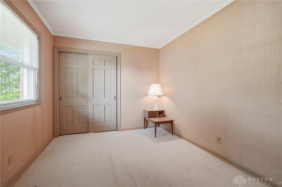 6119 Flemington Road Dayton, OH 45459 - Photo 36 of 76 This inviting bedroom features soft carpeting, a window with blinds, and convenient closet access.