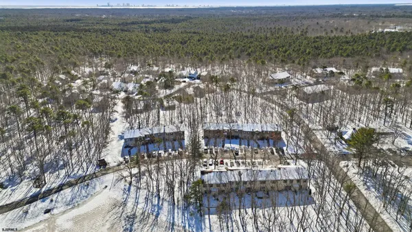 a view of a door with a bench and potted plant