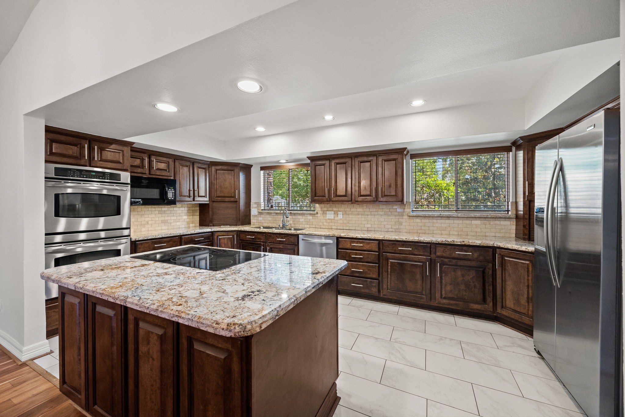 10310 Mayfield Road Houston, TX 77043 - Photo 20 of 49 Large kitchen has granite counters, nice stained cabinets with lots of storage
