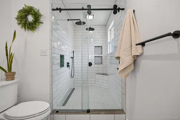 a bathroom with a toilet and a shower