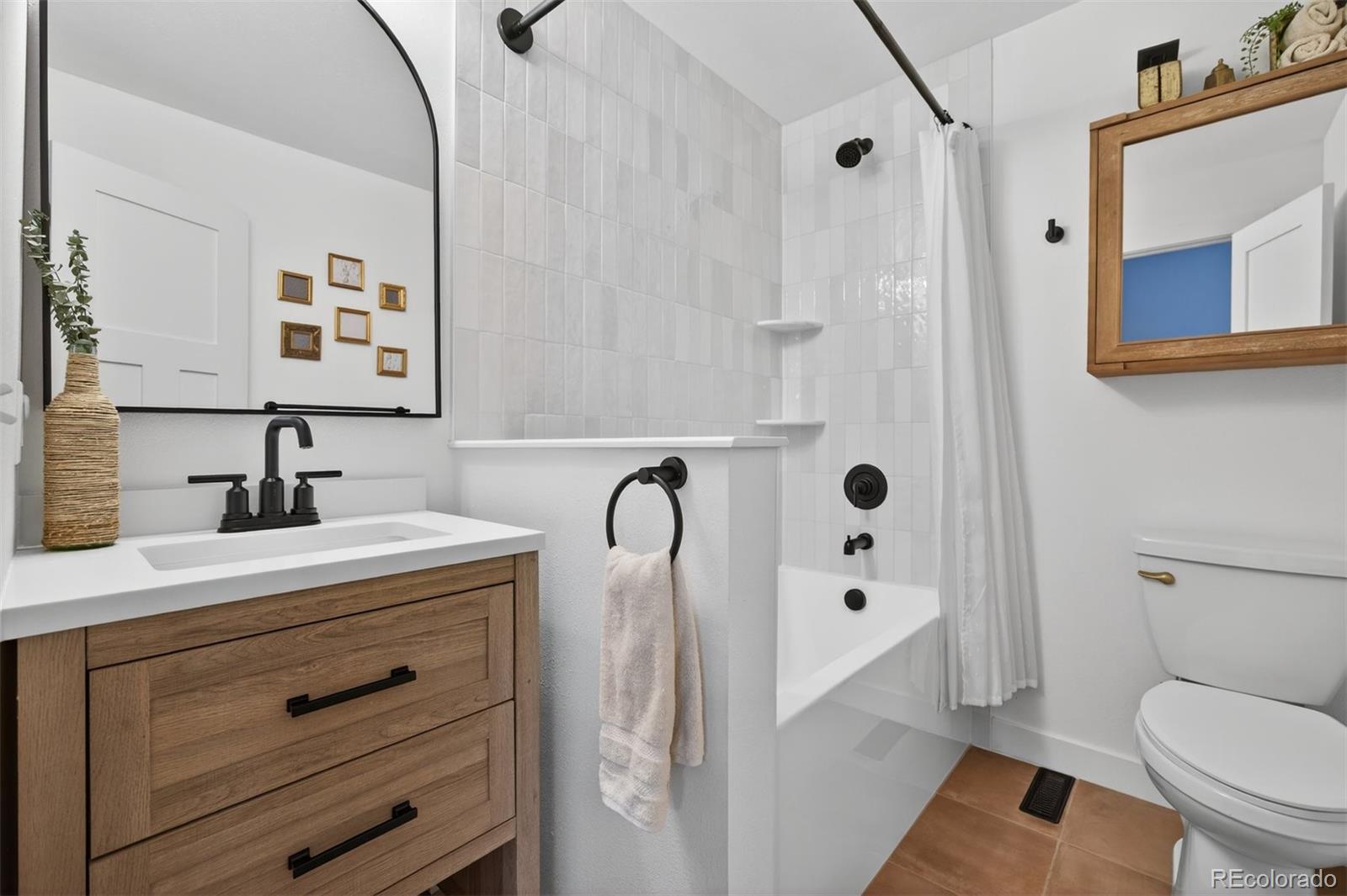 5915 South Birch Way Centennial, CO 80121 - Photo 13 of 22 a bathroom with a sink a toilet and shower