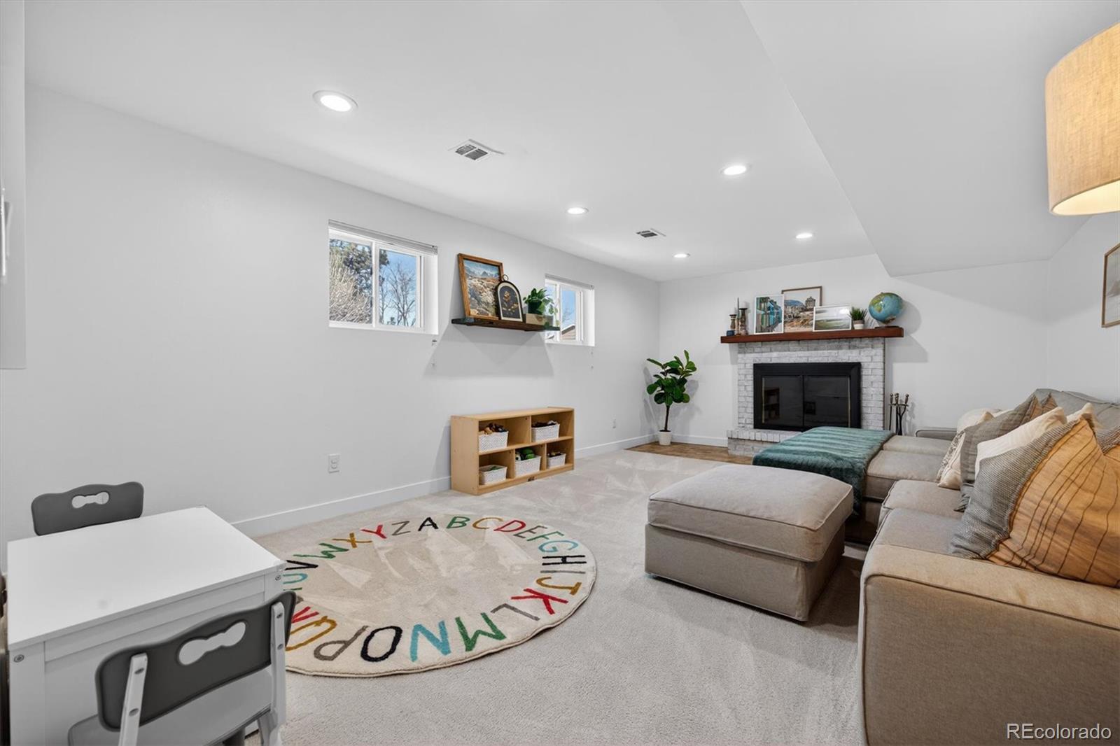 5915 South Birch Way Centennial, CO 80121 - Photo 15 of 22 a living room with furniture and a fireplace