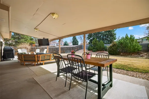 a view of a patio with a table and chairs