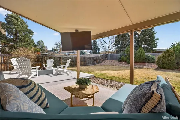 a view of a patio with couches chairs and swimming pool with a yard