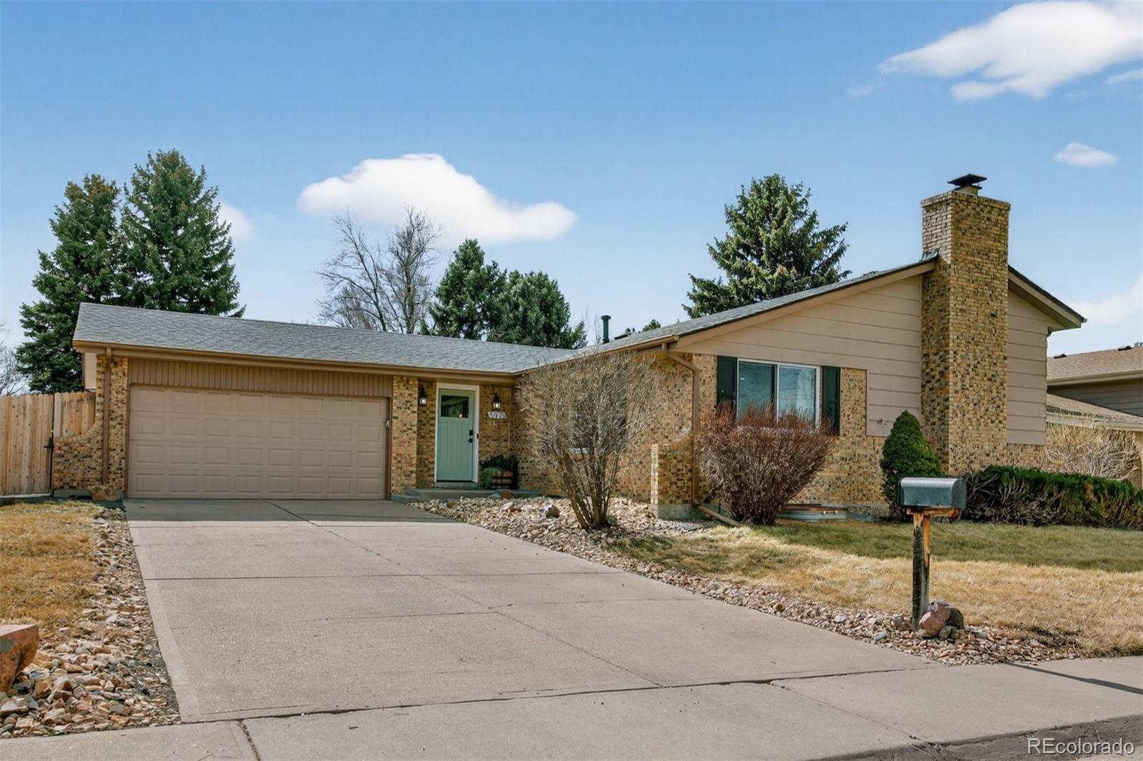 5915 South Birch Way Centennial, CO 80121 - Photo 22 of 22 a front view of a house with a yard and garage
