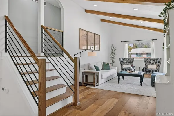 a living room with fireplace furniture and a wooden floor