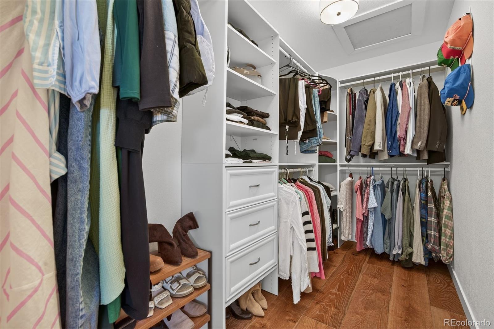 5915 South Birch Way Centennial, CO 80121 - Photo 9 of 22 a view of walk in closet with clothes and shoes