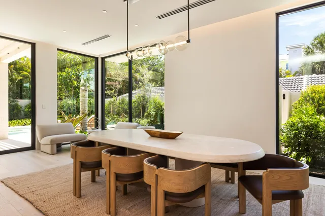 a living room with furniture large window and couch