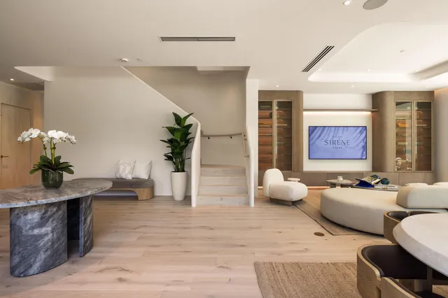 a living room with furniture a dining table and chairs