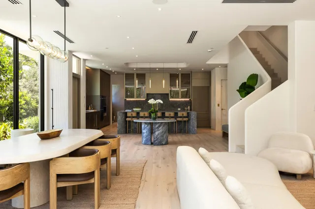 a dining room filled chandelier and wooden floor