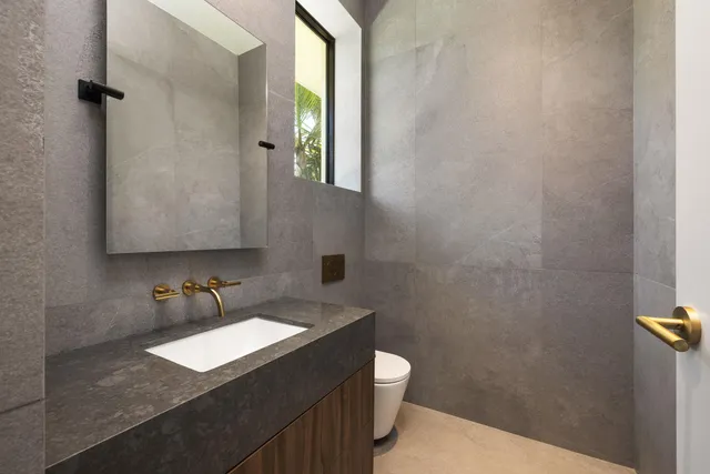 a white vase with white and yellow flowers