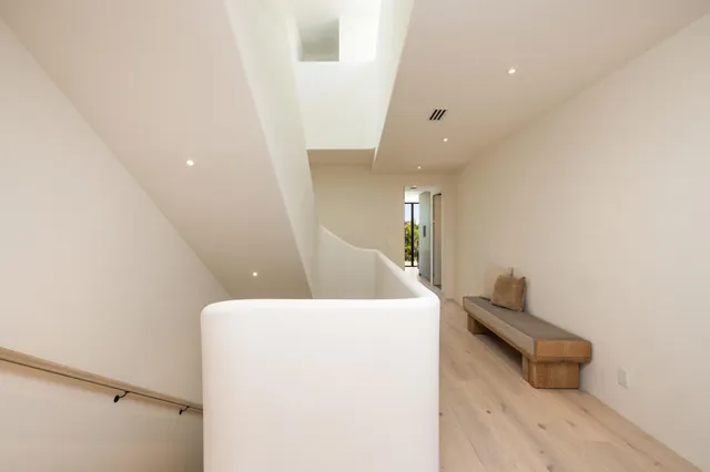 a large bed sitting in a bedroom next to a window