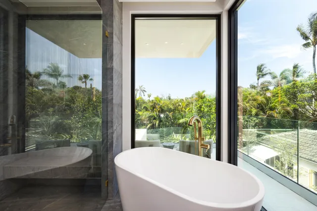a bathroom with a granite countertop sink a large mirror and a toilet