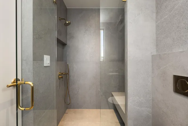 a bathroom with a sink toilet and window