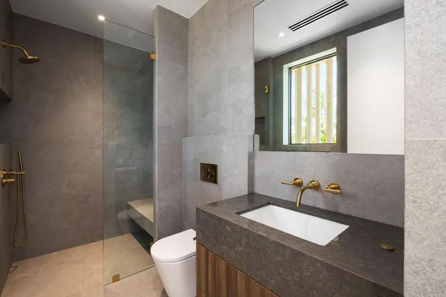 a kitchen with stainless steel appliances granite countertop a sink a refrigerator and a granite counter tops