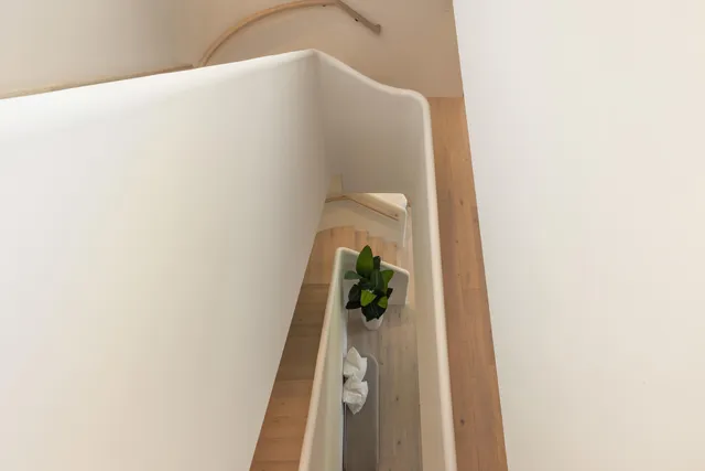 a balcony with furniture and a floor to ceiling window