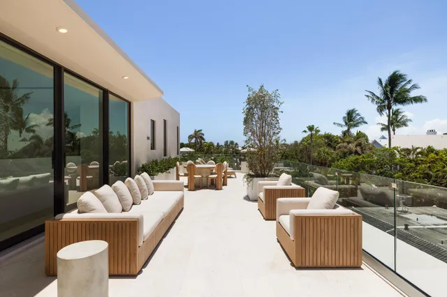 a view of a patio with table and chairs and wooden floor