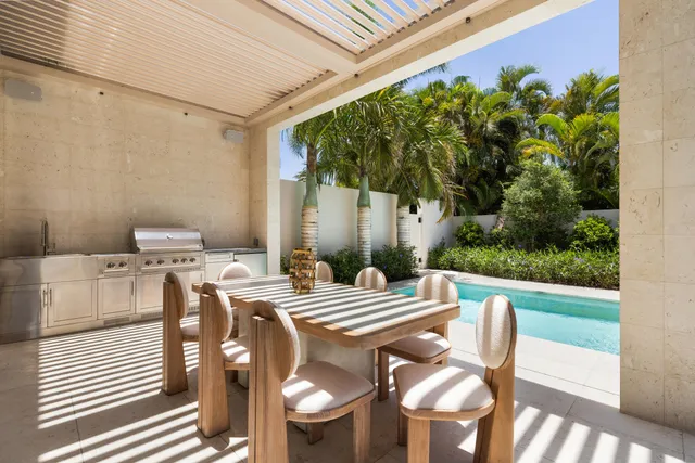 a view of a patio with table and chairs potted plants with wooden floor and fence