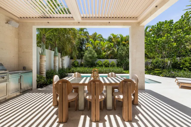 a view of a patio with a dining table and chairs