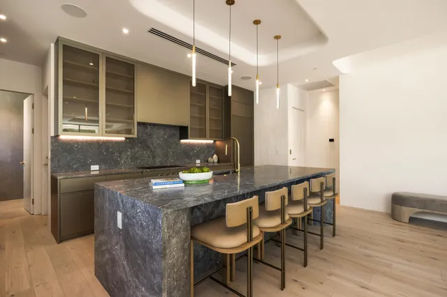 a kitchen with sink and view of living room