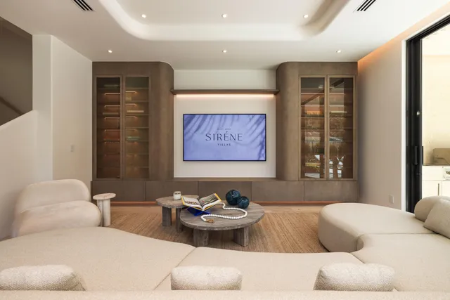 a living room with furniture and large windows